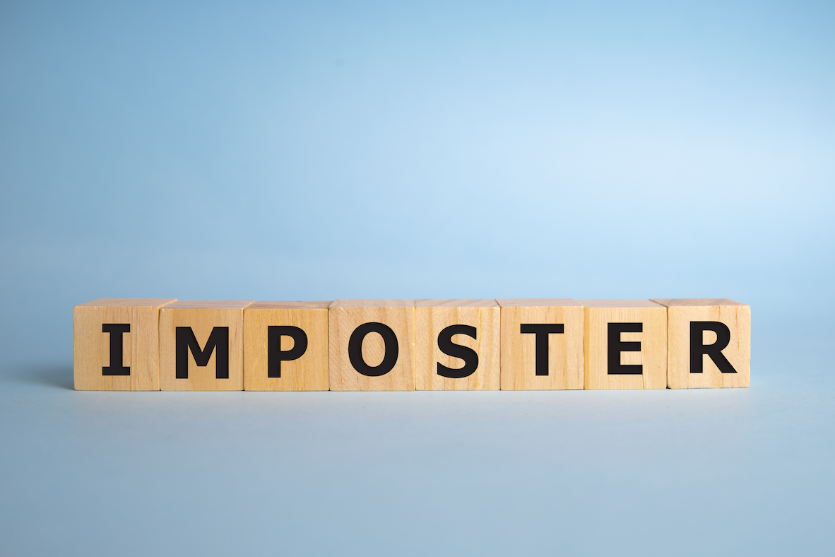 Building blocks spelling out the word "Imposter" with a blue background