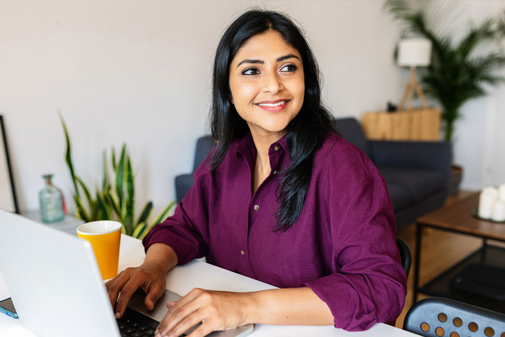 online student thinking at desk on computer 