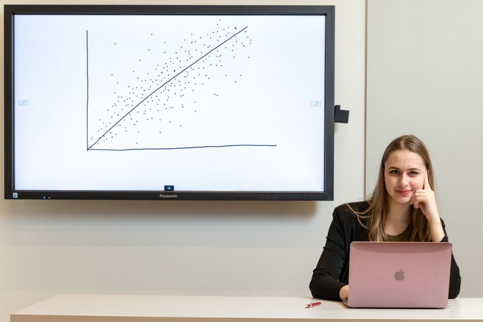 Female graduate student sitting in front of a graph with her laptop