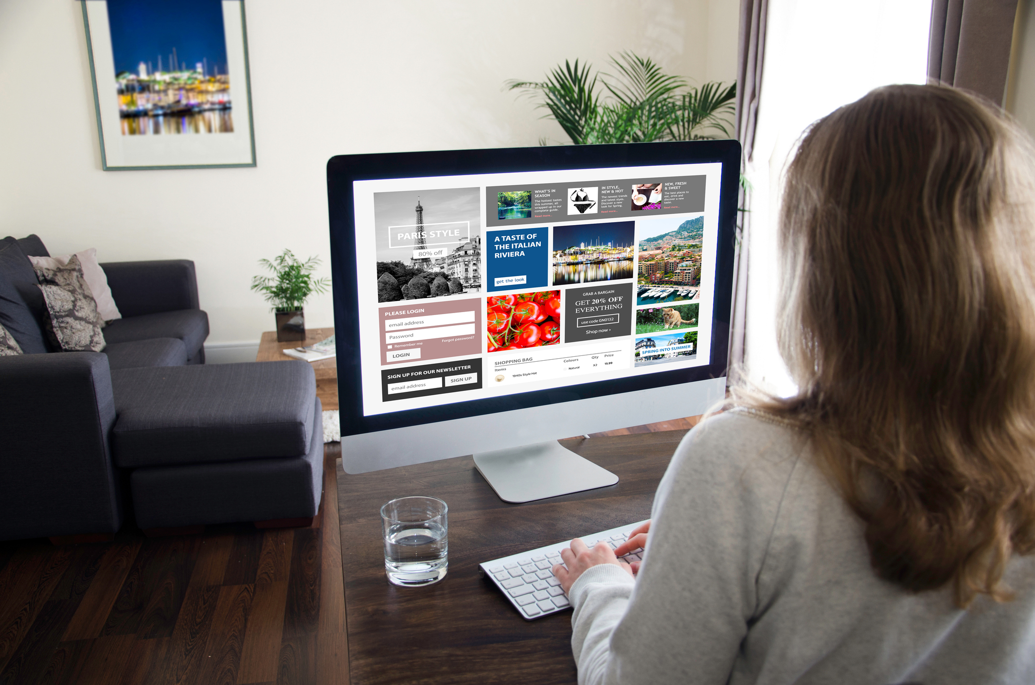 Female student sitting at home in front of a computer monitor working on designing her eportfolio