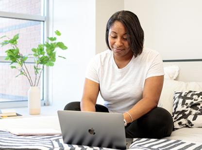 Student doing classwork at home in the comfort of their room