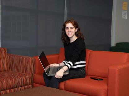 Photo of a student sitting in a lounge area