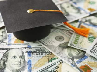 Photo of US Currency and a graduation cap