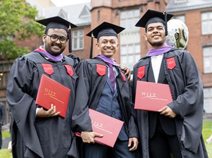 group of NJIT graduates holding their diplomas