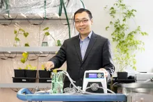 Engineer standing in front of testing equipment 